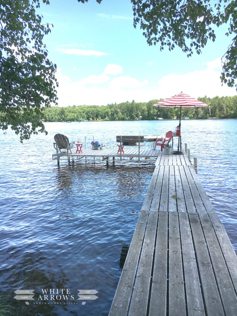 dock, stripped umbrella, adirondack chairs, lake hous