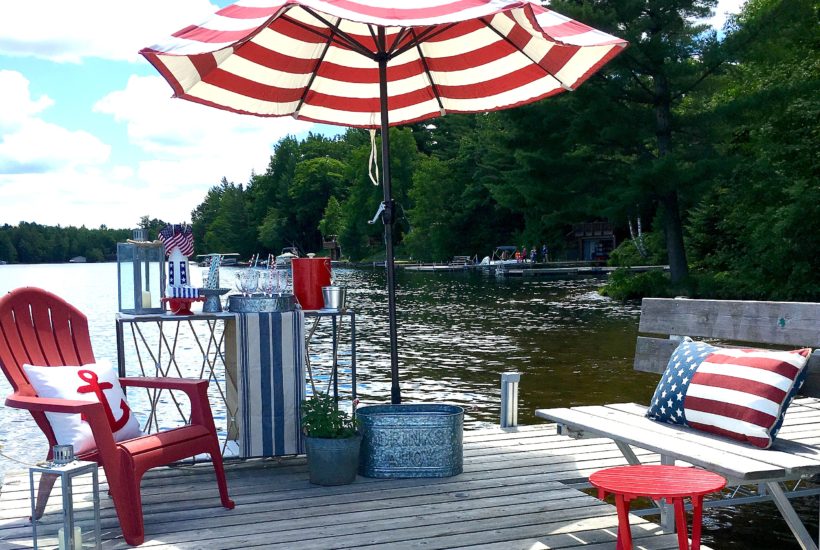 dock, stripped umbrella, adirondack chairs, lake house