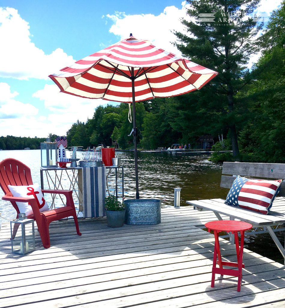 dock, stripped umbrella, adirondack chairs, lake house
