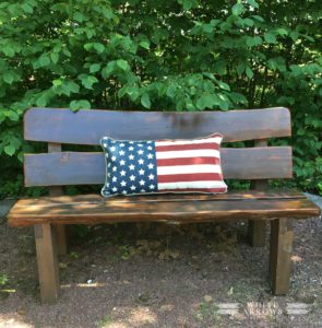 wooden bench, american flag pillow, fire pit
