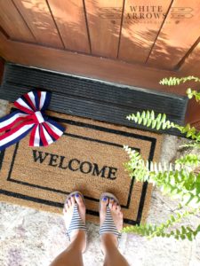 front porch, welcome rug, fern
