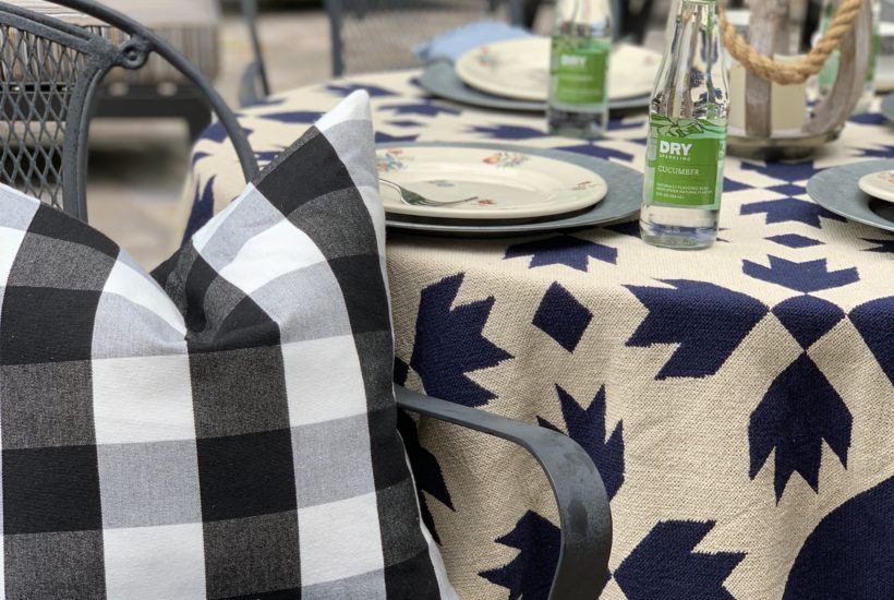 Summer outdoor tablescape with buffalo plaid pillow