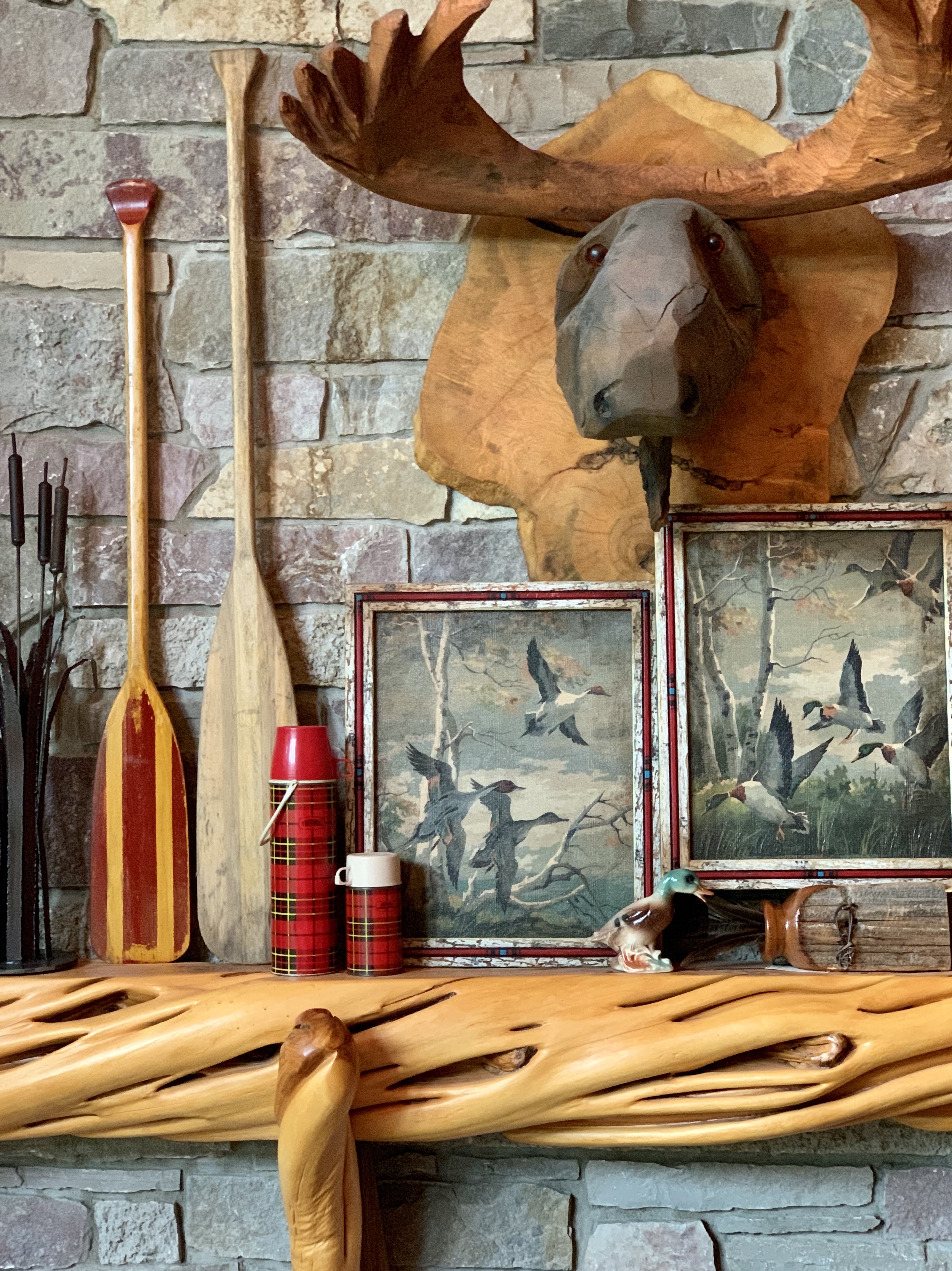 Vintage paddles on cabin mantel