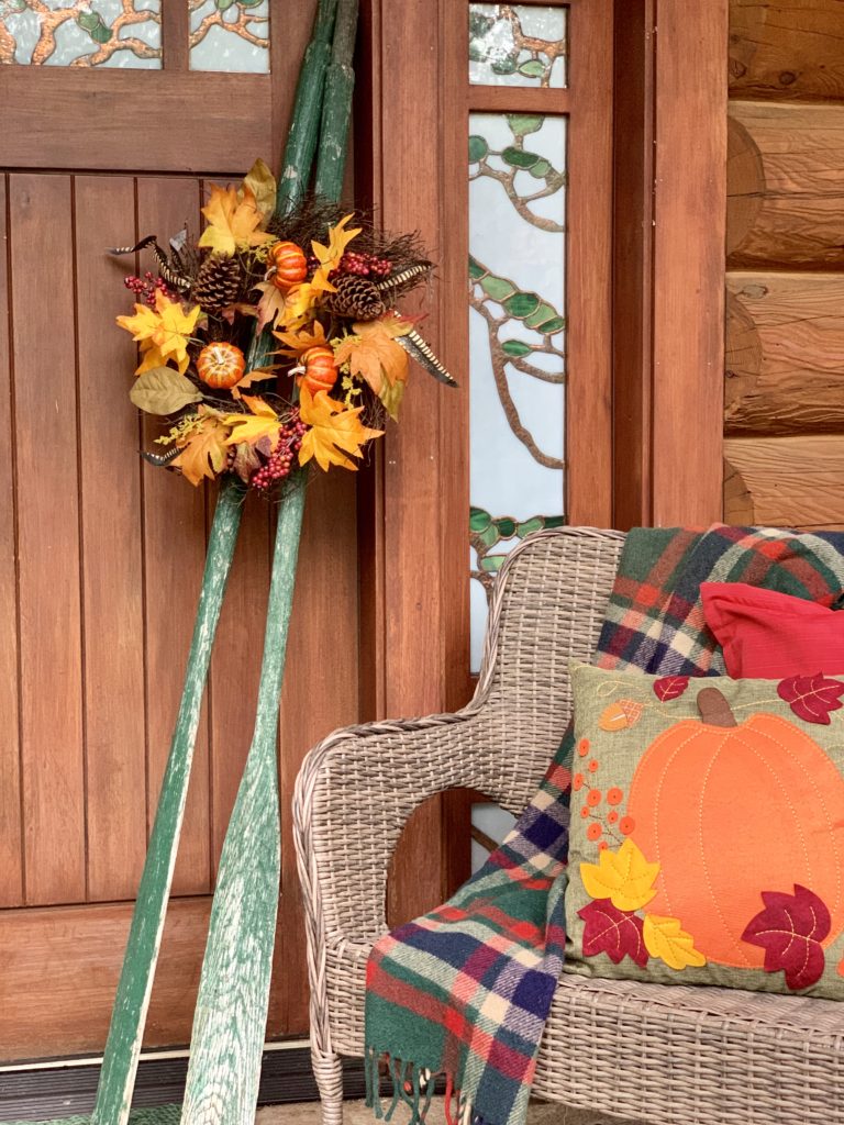 Fall Porch at Lake House Cabin Oars hold a wreath