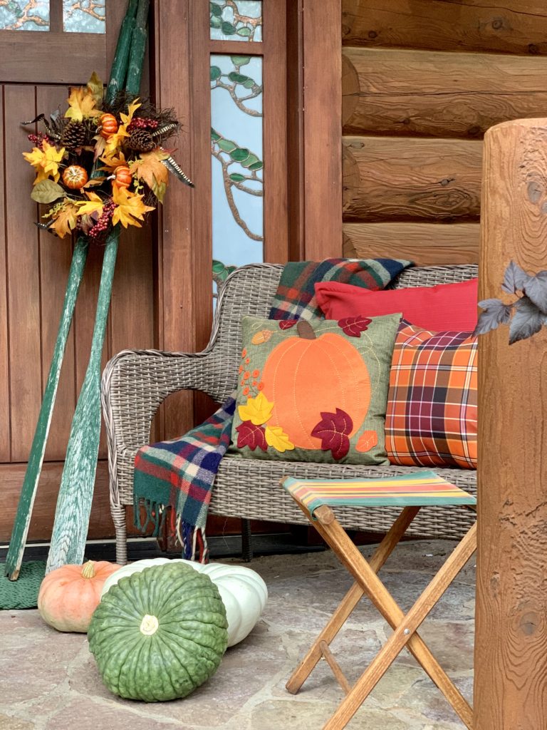 Front Porch of Lake House Cabin decorated for Fall in oranges and greens
