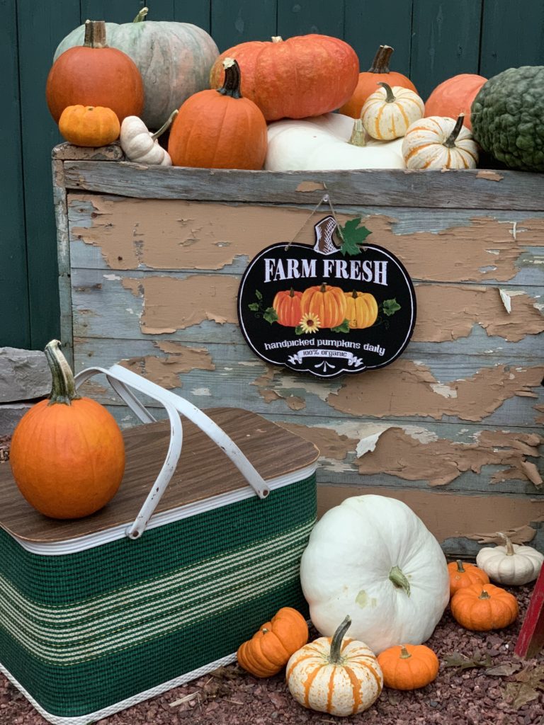 Fall porch vintage green picnic basket and pumpkins