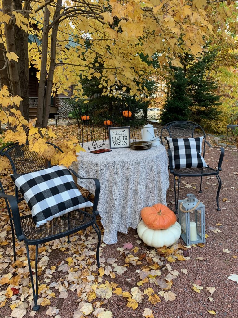 Table Decorated for Halloween Outside under tree with yellow leaves