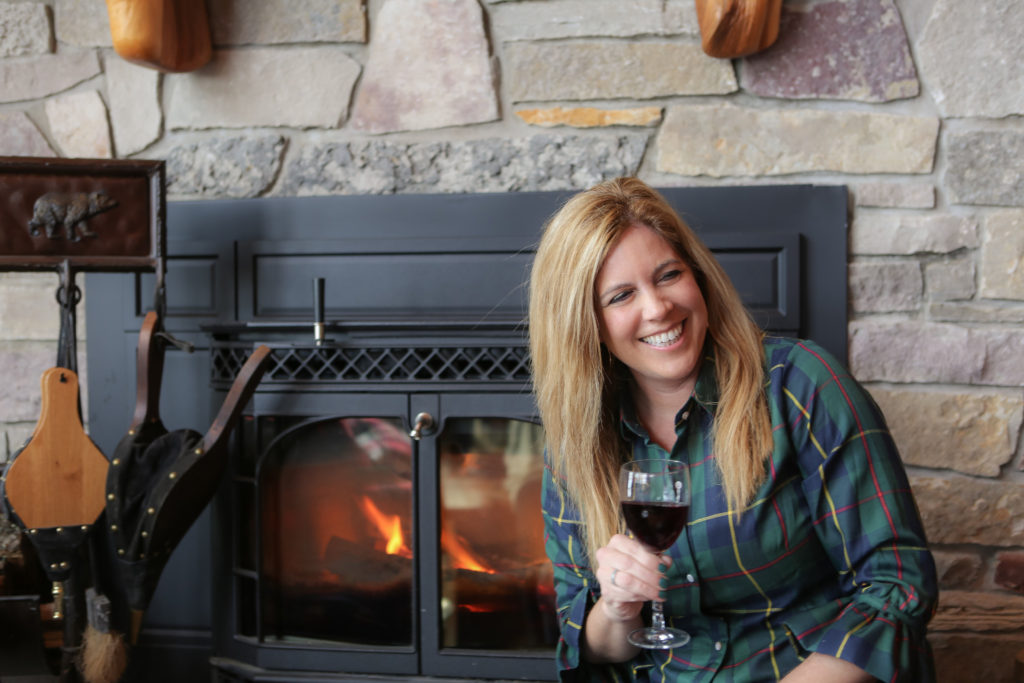 Kristin Lenz by the fireplace