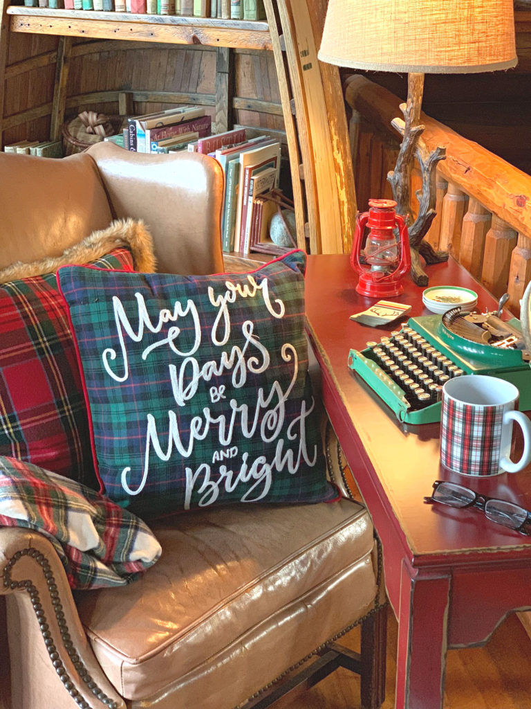 Christmas desk with leather chair plaid throw pillows and vintage typewriter