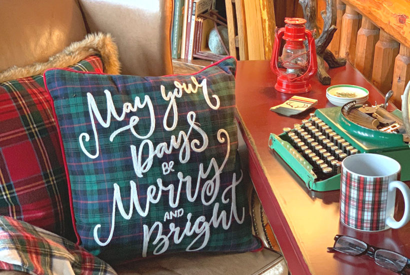 Christmas desk with leather chair plaid throw pillows and vintage typewriter