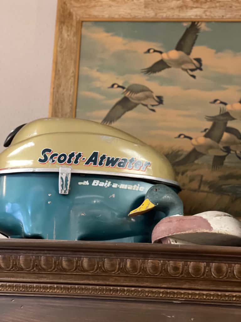 Vintage boat motor, artwork and duck decoy