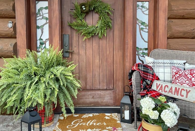 Summer porch decor with ferns and hydrangeas.