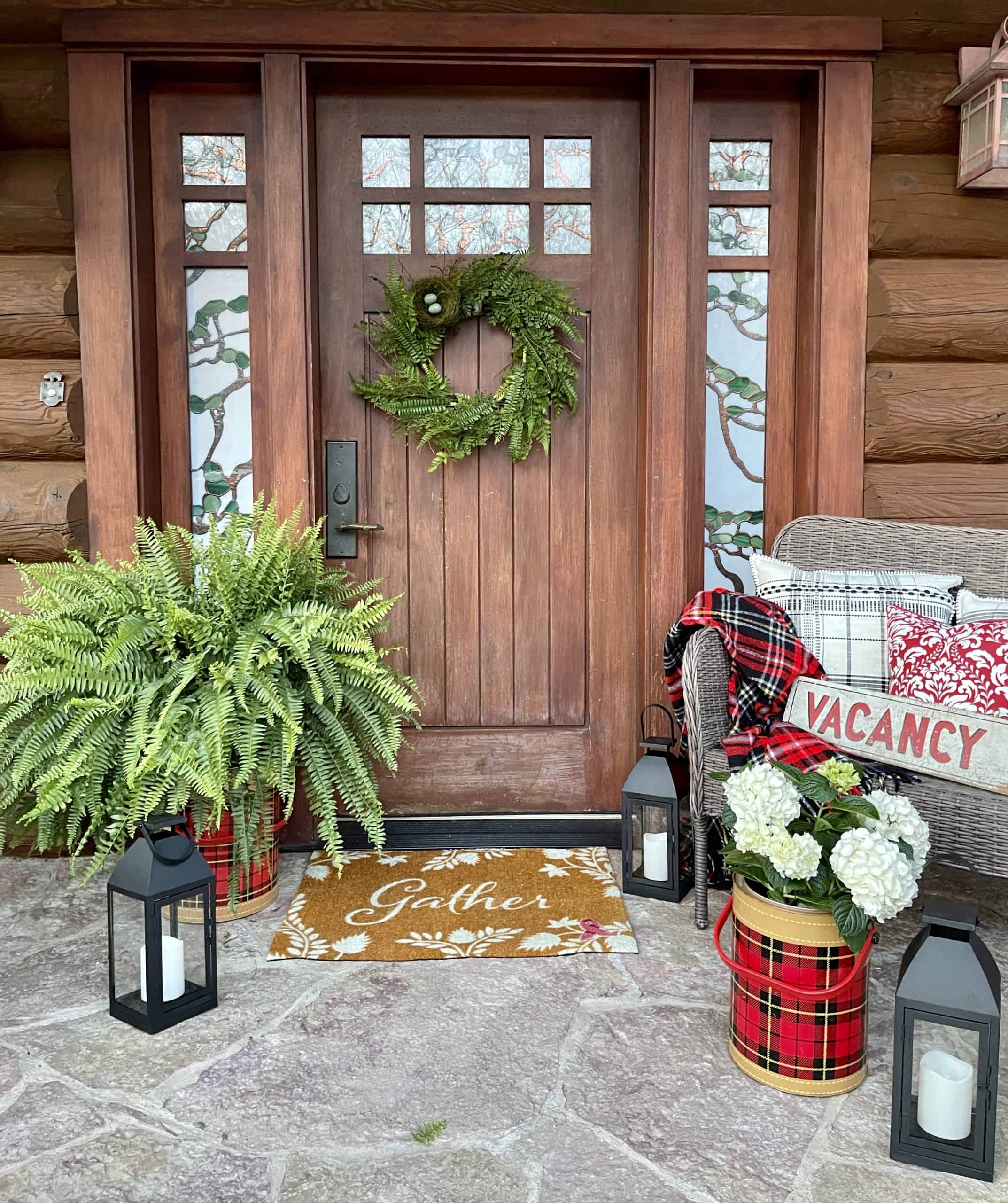 Summer porch decor with ferns and hydrangeas.