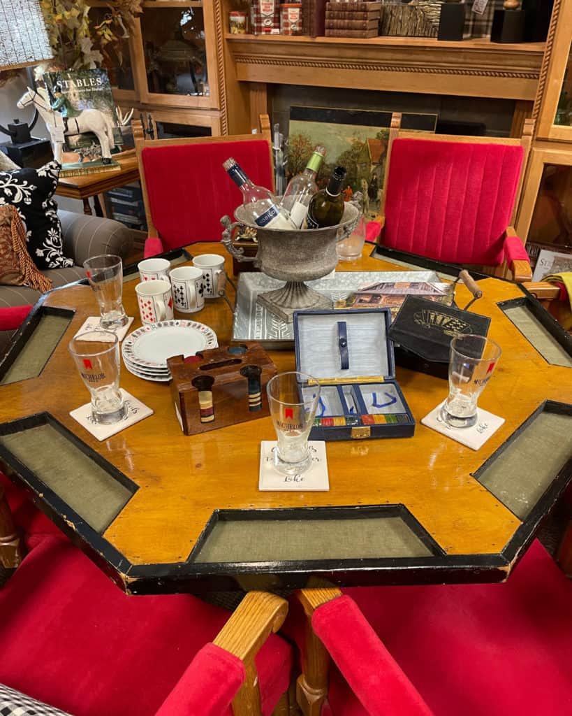 Antique Poker Table with velvet chairs from White Arrows Home