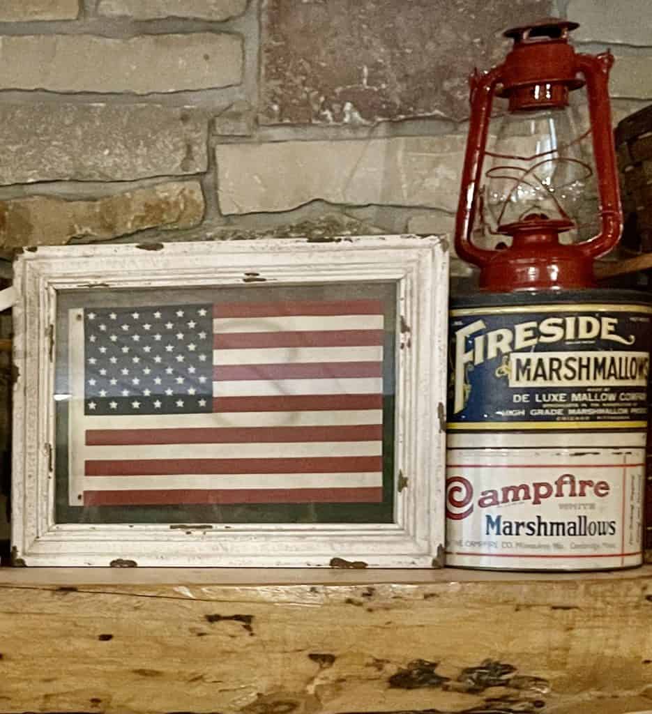 Cabin Mantel Decor with Vintage picnic baskets, lanterns and flags