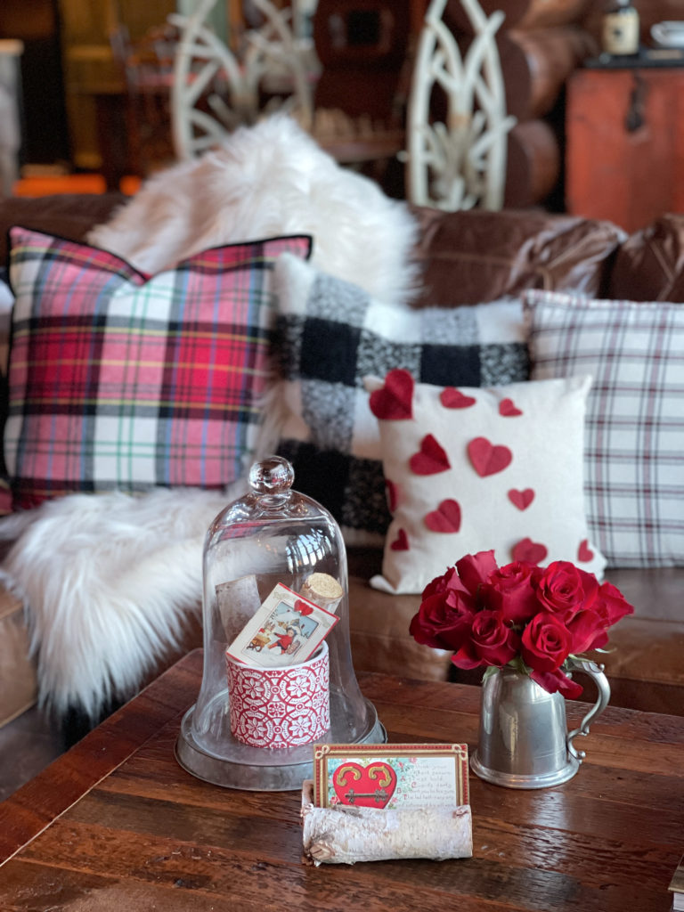 Valentine decor with a vintage card and cloche in the cabin