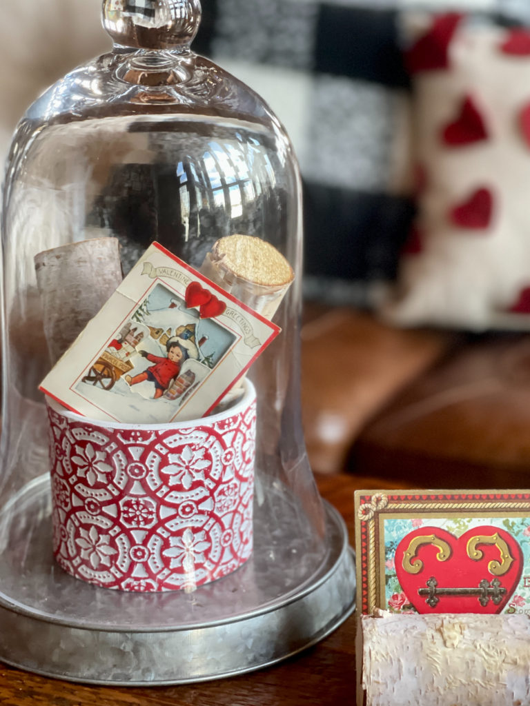Valentine decor with a vintage card and cloche.