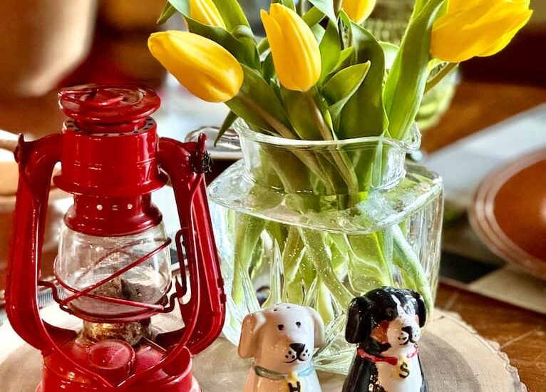 A yellow tulip centerpiece on the table at the cabin